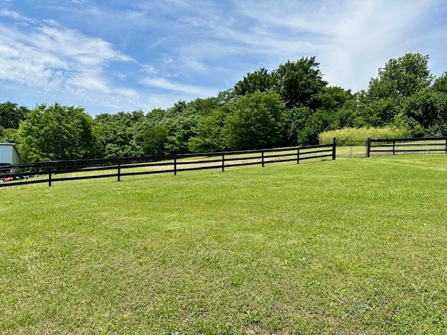 view of yard with a rural view