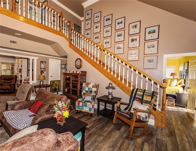 living room featuring crown molding, high vaulted ceiling, and hardwood / wood-style floors