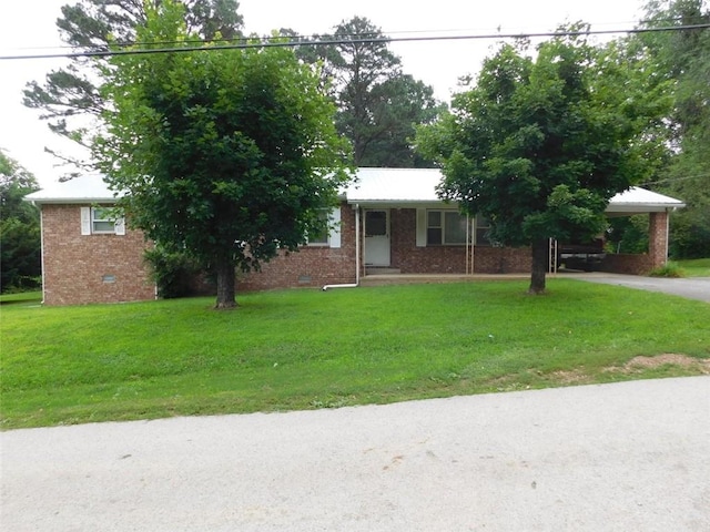 single story home with a front yard and a carport