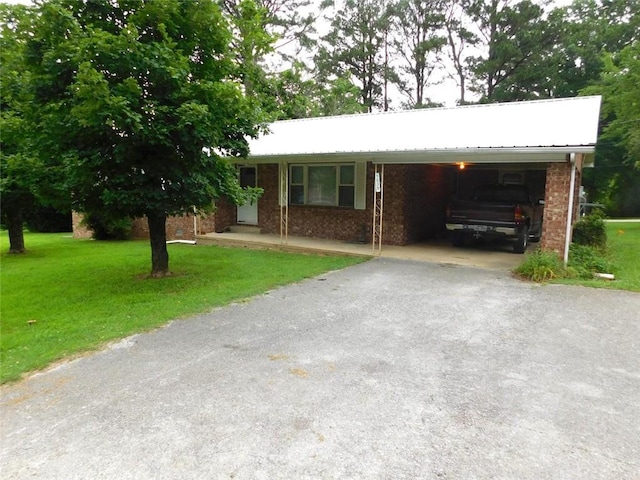 single story home with a front lawn and a carport