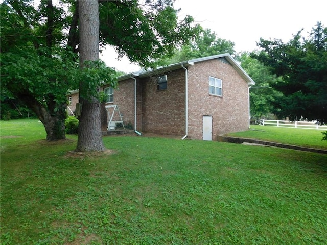 view of property exterior featuring a lawn