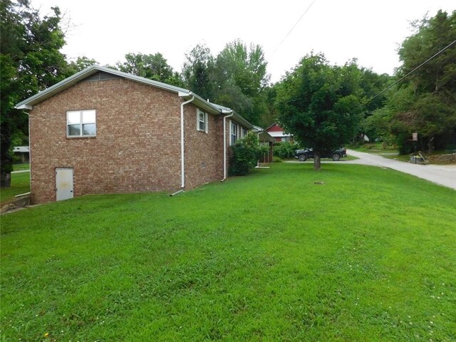 view of side of property with a yard