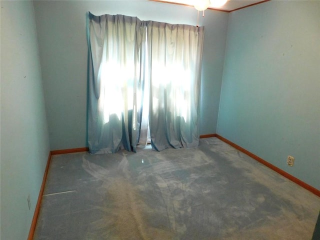 spare room featuring dark colored carpet