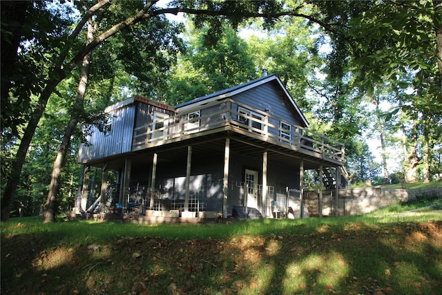 rear view of property with a wooden deck