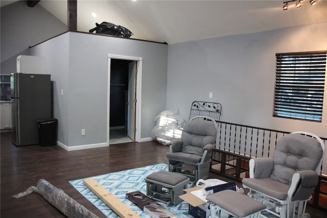 living room featuring vaulted ceiling and dark hardwood / wood-style floors