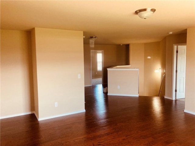 empty room with dark hardwood / wood-style floors