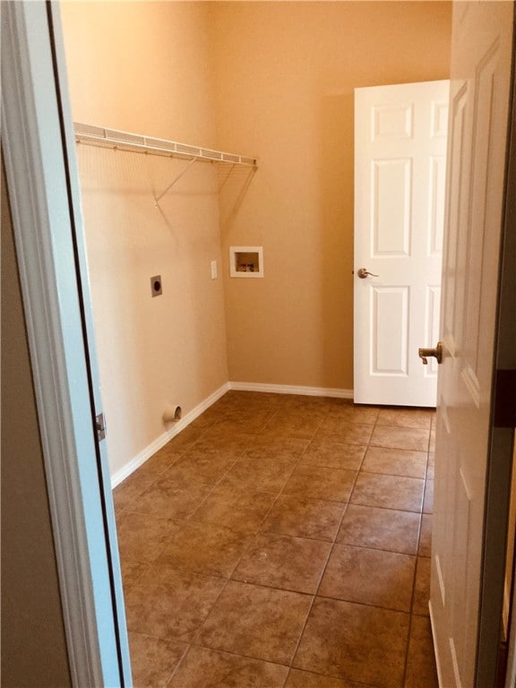 laundry area featuring baseboards, laundry area, electric dryer hookup, washer hookup, and tile patterned flooring