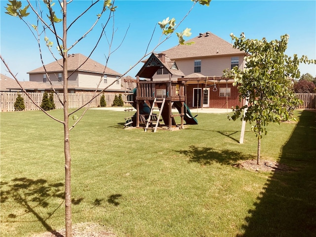 view of yard with a playground and fence