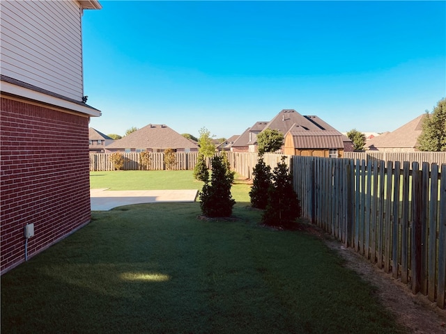 view of yard featuring a residential view and a fenced backyard