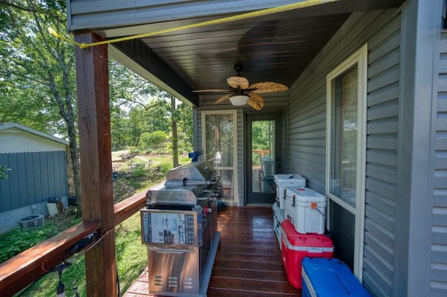 wooden deck featuring ceiling fan