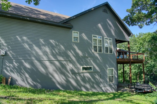 view of side of property featuring a wooden deck