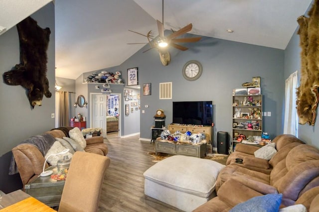 living room with hardwood / wood-style floors, ceiling fan, and vaulted ceiling