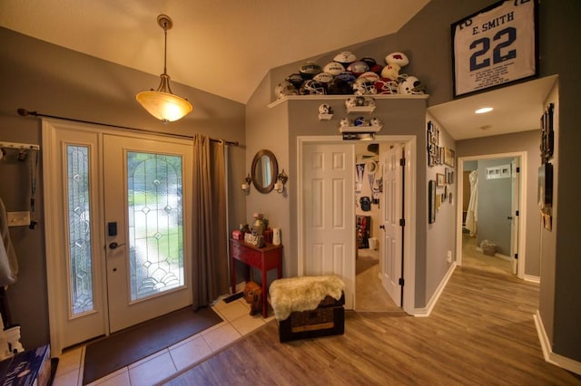 foyer featuring hardwood / wood-style floors and lofted ceiling