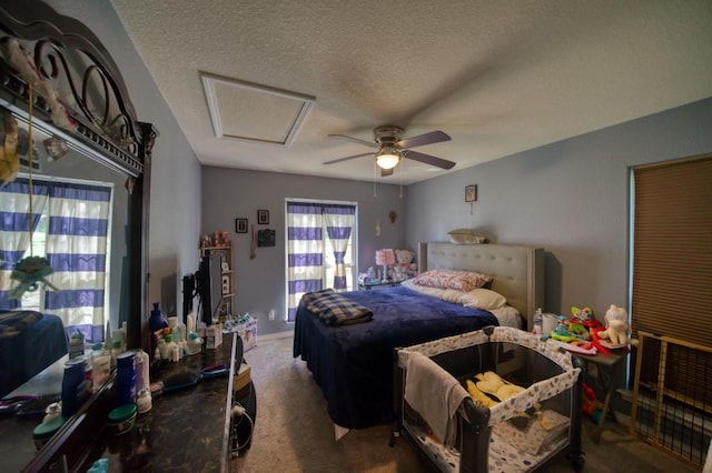 bedroom featuring carpet flooring, a textured ceiling, and ceiling fan