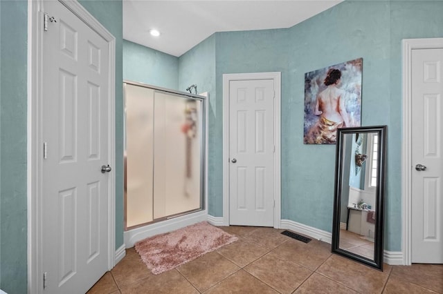 bathroom featuring an enclosed shower and tile patterned floors