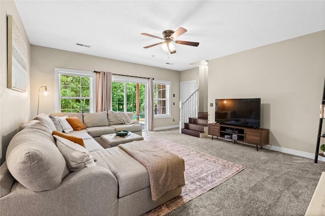 carpeted living room featuring ceiling fan