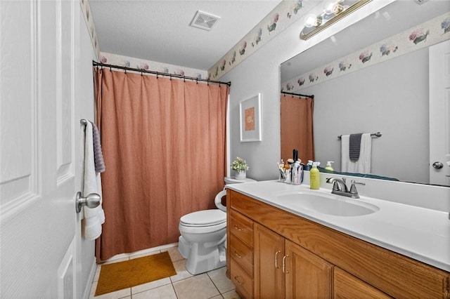 bathroom with vanity, tile patterned floors, a textured ceiling, and toilet