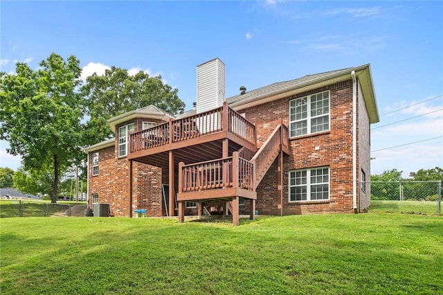 back of house with a wooden deck, a yard, and central air condition unit