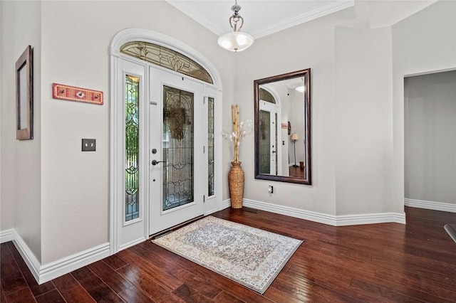 entrance foyer with crown molding and dark wood-type flooring