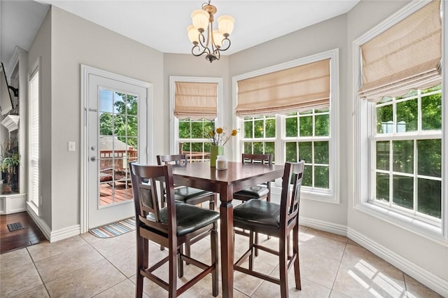 dining room featuring an inviting chandelier and light tile patterned flooring