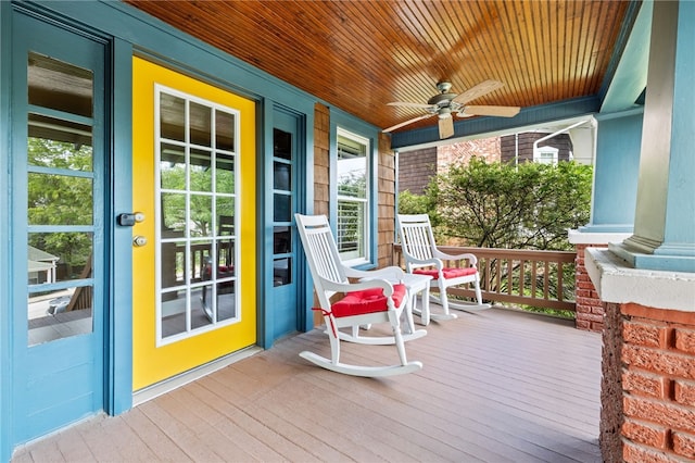 wooden deck with a porch and ceiling fan