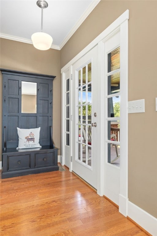 doorway featuring wood-type flooring and crown molding