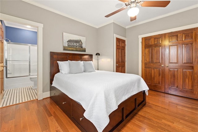 bedroom featuring connected bathroom, ceiling fan, hardwood / wood-style floors, a closet, and ornamental molding