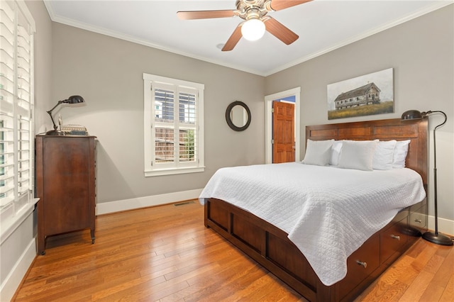 bedroom with ceiling fan, crown molding, and light wood-type flooring