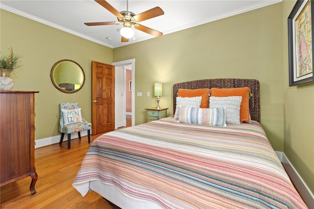 bedroom with ceiling fan, light hardwood / wood-style floors, and ornamental molding