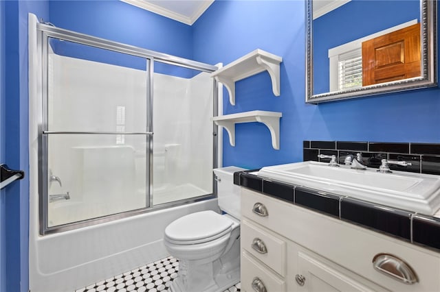 full bathroom featuring combined bath / shower with glass door, vanity, toilet, and crown molding