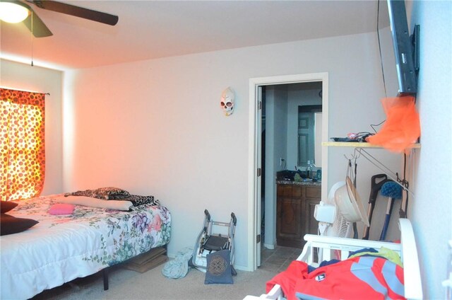 bedroom featuring ensuite bathroom, ceiling fan, and carpet floors