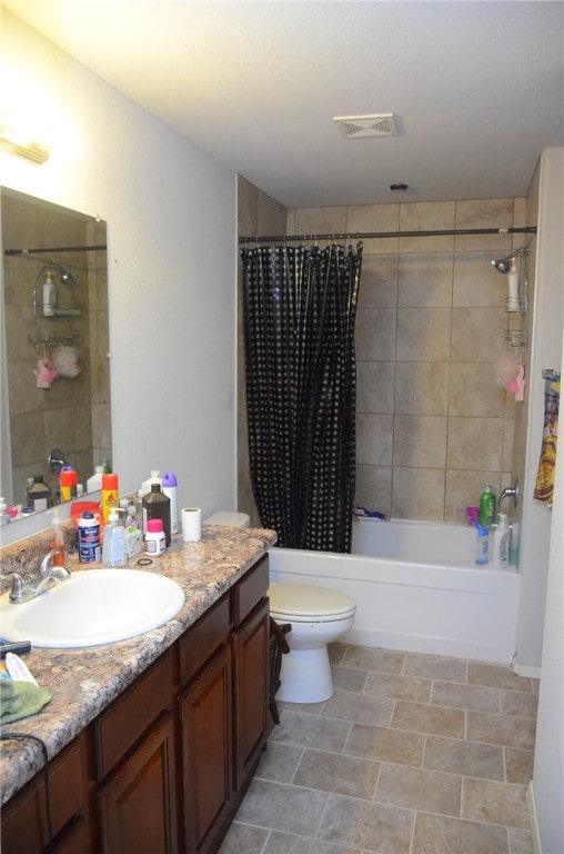 full bathroom featuring tile floors, shower / tub combo, vanity, and toilet