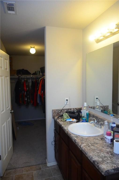 bathroom featuring tile flooring and vanity