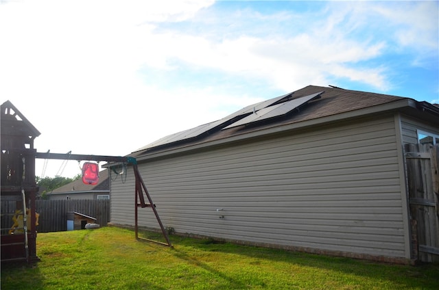 view of side of property with a lawn