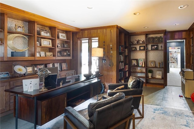 home office with ornamental molding and wooden walls