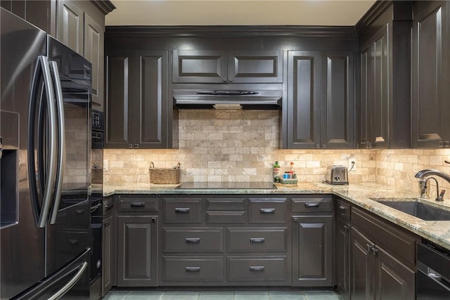 kitchen with decorative backsplash, sink, dark brown cabinetry, and black appliances