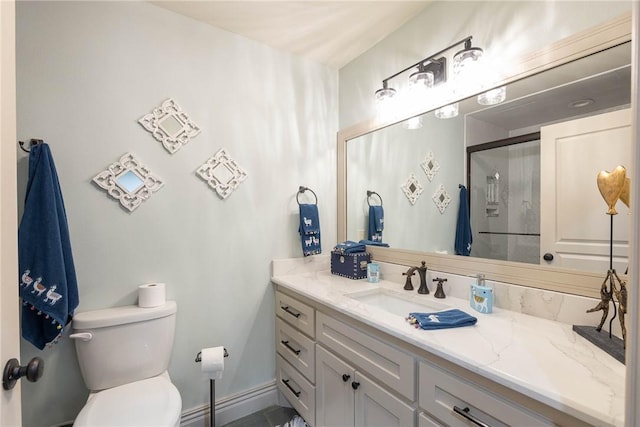 bathroom featuring toilet, walk in shower, and vanity