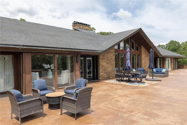 back of house featuring a patio area and an outdoor living space