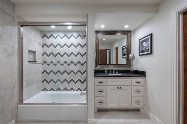 bathroom featuring tile patterned flooring, enclosed tub / shower combo, and vanity