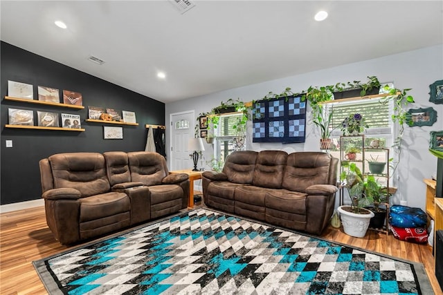 living room featuring hardwood / wood-style flooring and vaulted ceiling