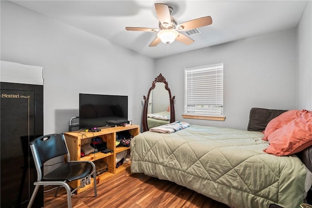 bedroom with ceiling fan and wood-type flooring