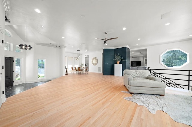 living area featuring healthy amount of natural light, recessed lighting, a ceiling fan, ornamental molding, and wood finished floors