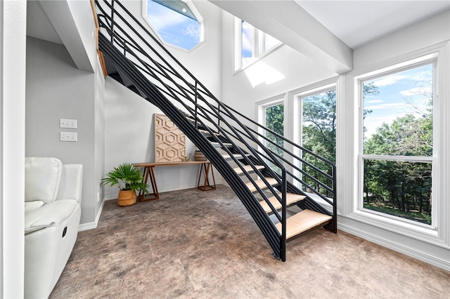 staircase with baseboards and carpet floors
