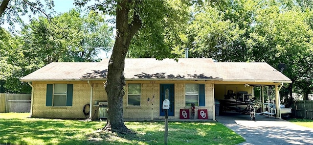 view of front facade with a carport and a front yard