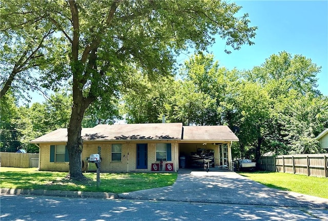 ranch-style home with a front yard and a carport