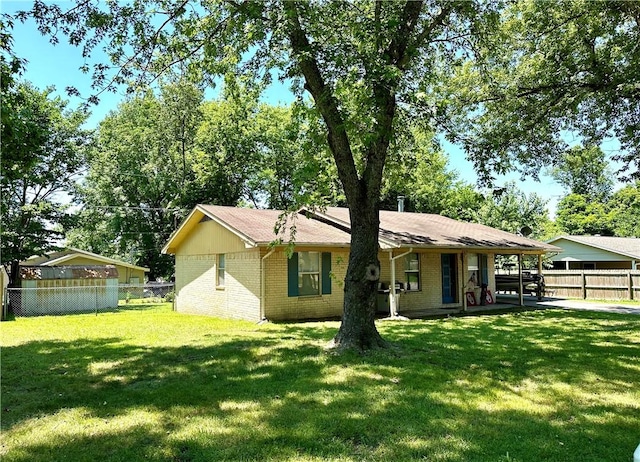 rear view of house featuring a yard