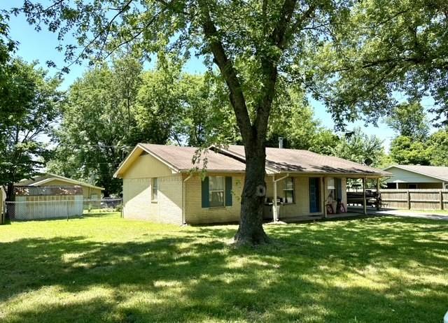 rear view of property featuring a yard