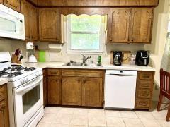 kitchen featuring sink, white appliances, and light tile patterned flooring