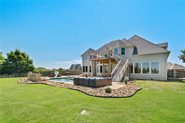 rear view of house featuring a fenced in pool, a balcony, an outdoor hangout area, and a yard