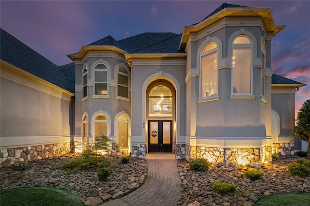 exterior entry at dusk with french doors